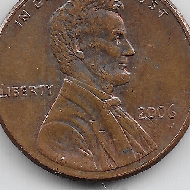 2006 penny Doubled Die Obverse DDO error showing hub doubling on LIBERTY letters under magnification